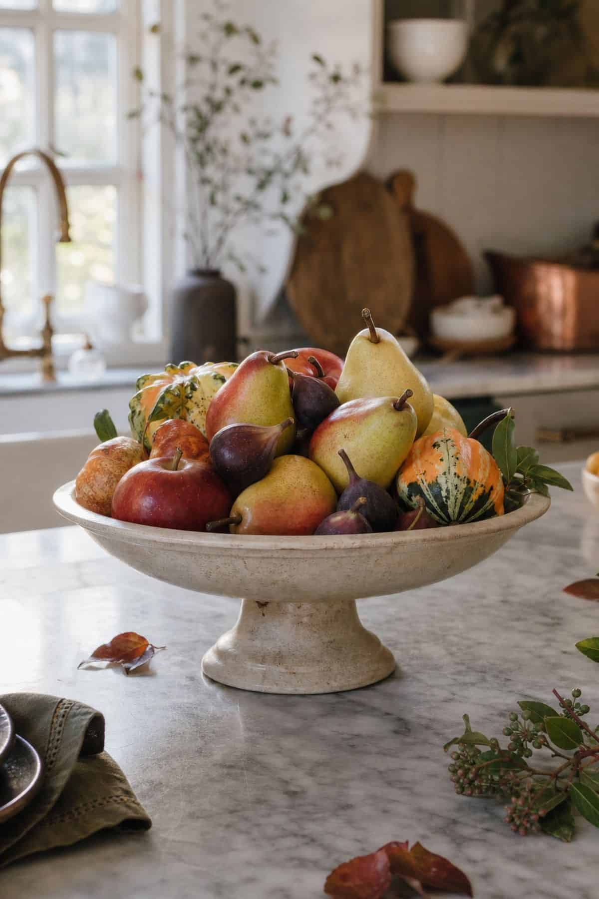 Pedestal Fruit Bowl shown as a realistic Pretty Wild World image for 17 Fall Kitchen Decor Ideas That Work in Real Life.
