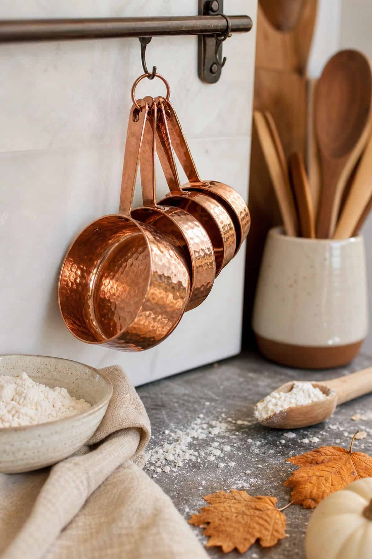 Copper Measuring Cups shown as a realistic Pretty Wild World image for 17 Fall Kitchen Decor Ideas That Work in Real Life.