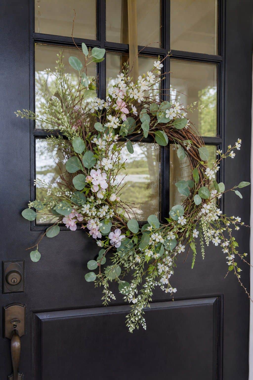 Loose Spring Wreath shown as a realistic Pretty Wild World image for 18 Front Porch Spring Decor Ideas With Fresh Curb Appeal.