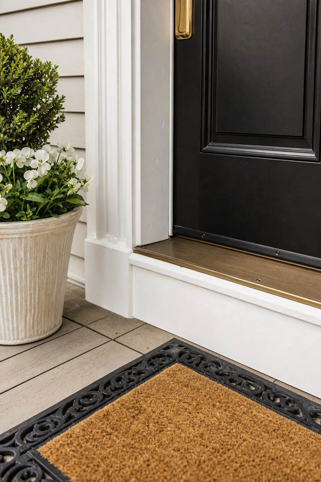 Clean Threshold Reset shown as a realistic Pretty Wild World image for 18 Front Porch Spring Decor Ideas With Fresh Curb Appeal.