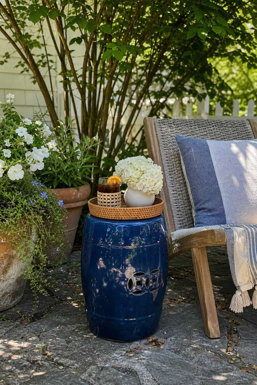 Ceramic Garden Stool shown as a realistic Pretty Wild World image for 20 Summer Garden Decor Ideas for a Relaxed Outdoor Escape.