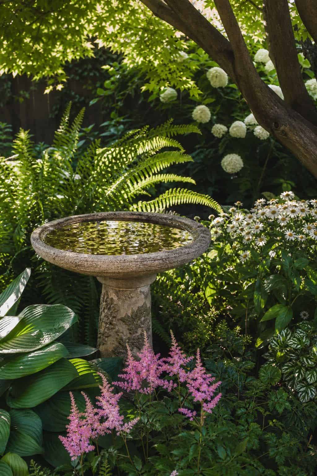Birdbath Moment shown as a realistic Pretty Wild World image for 20 Summer Garden Decor Ideas for a Relaxed Outdoor Escape.