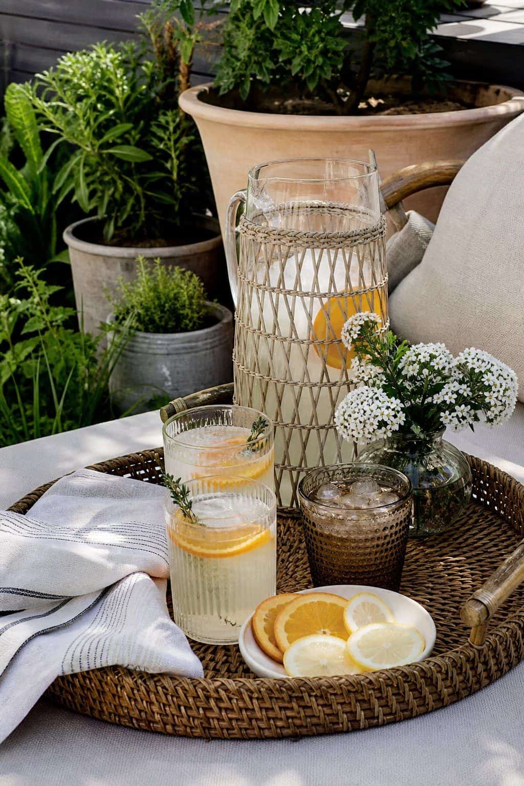 Outdoor Tray for Drinks shown as a realistic Pretty Wild World image for 20 Summer Garden Decor Ideas for a Relaxed Outdoor Escape.