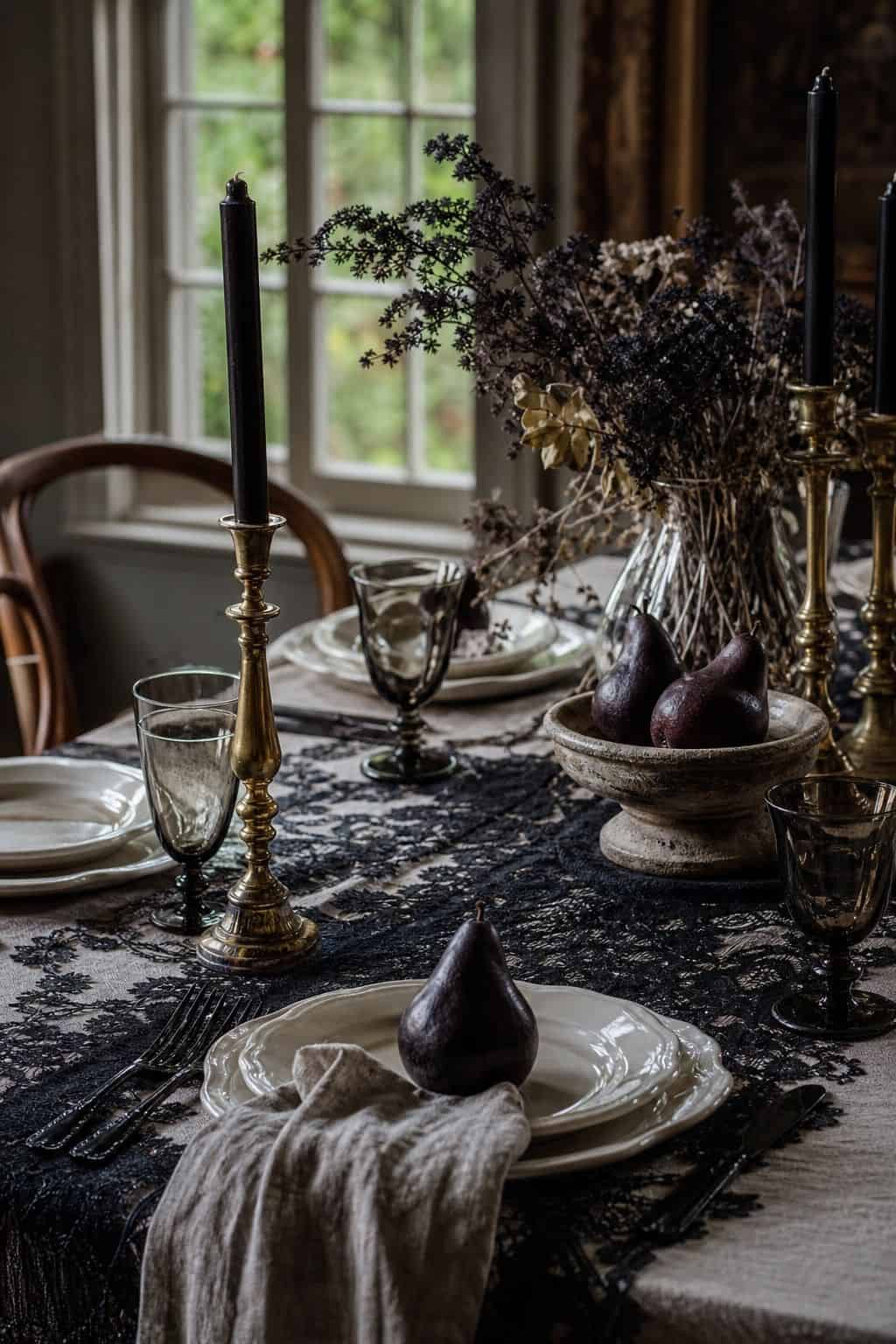 Black lace table runner layered into elegant Halloween dining decor