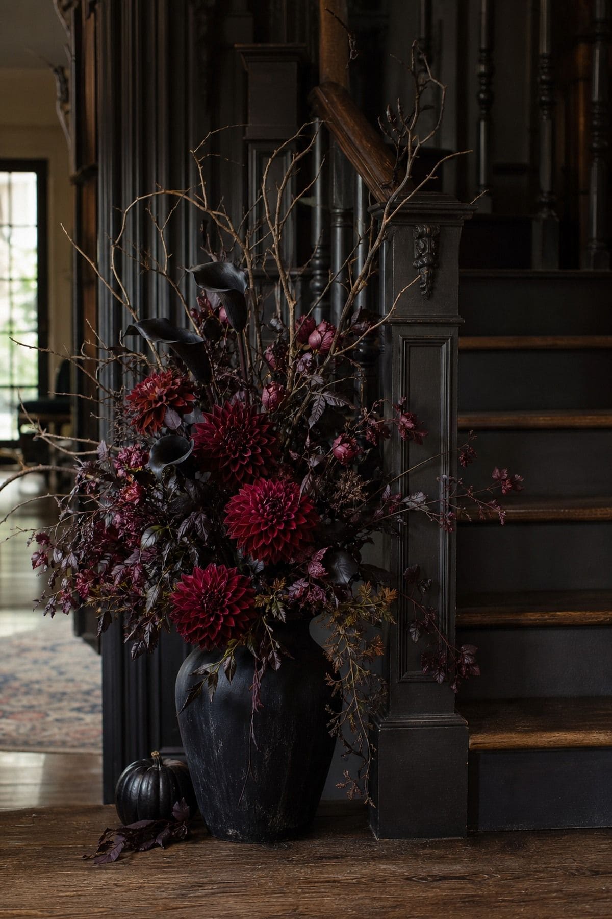 Dark Florals at the Base shown as a realistic Pretty Wild World image for 16 Halloween Staircase Decor Ideas for a Spooky Grand Entrance.