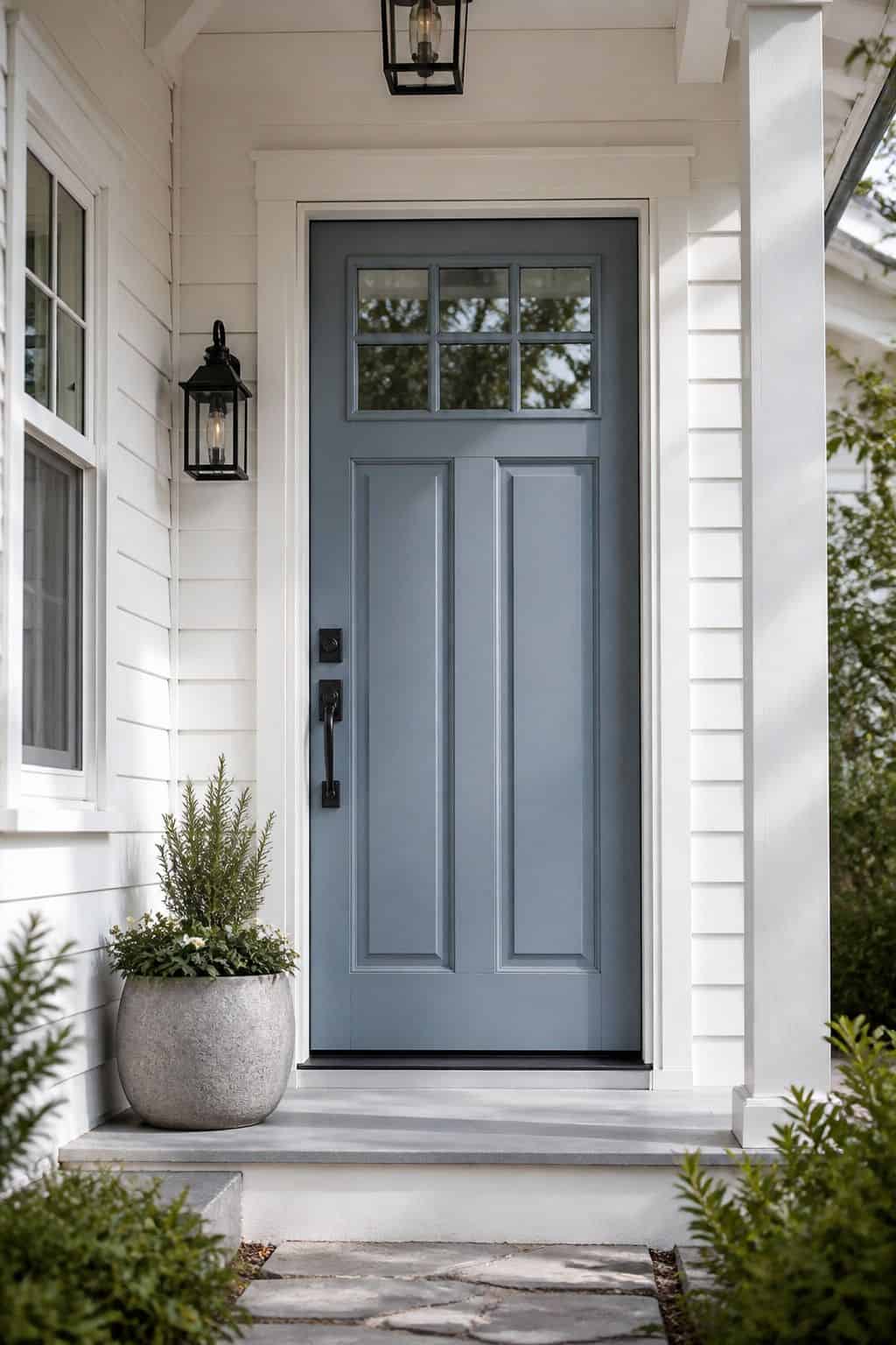 Blue-Gray Front Door shown as a realistic Pretty Wild World image for 16 Coastal Home Exterior Ideas for Breezy Curb Appeal.