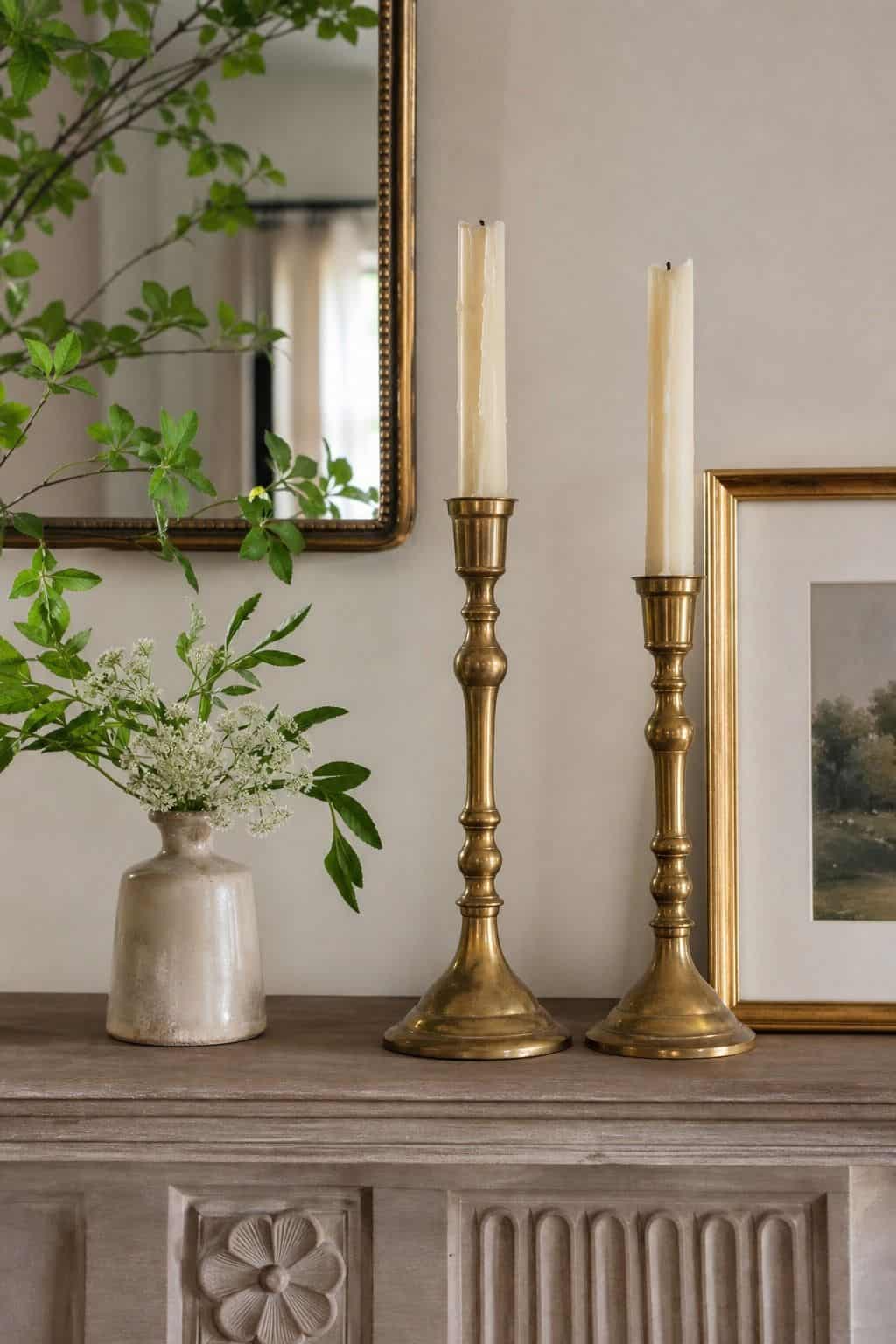Brass Candle Pair shown as a realistic Pretty Wild World image for 16 Summer Mantel Decorating Ideas for a Light Collected Fireplace.