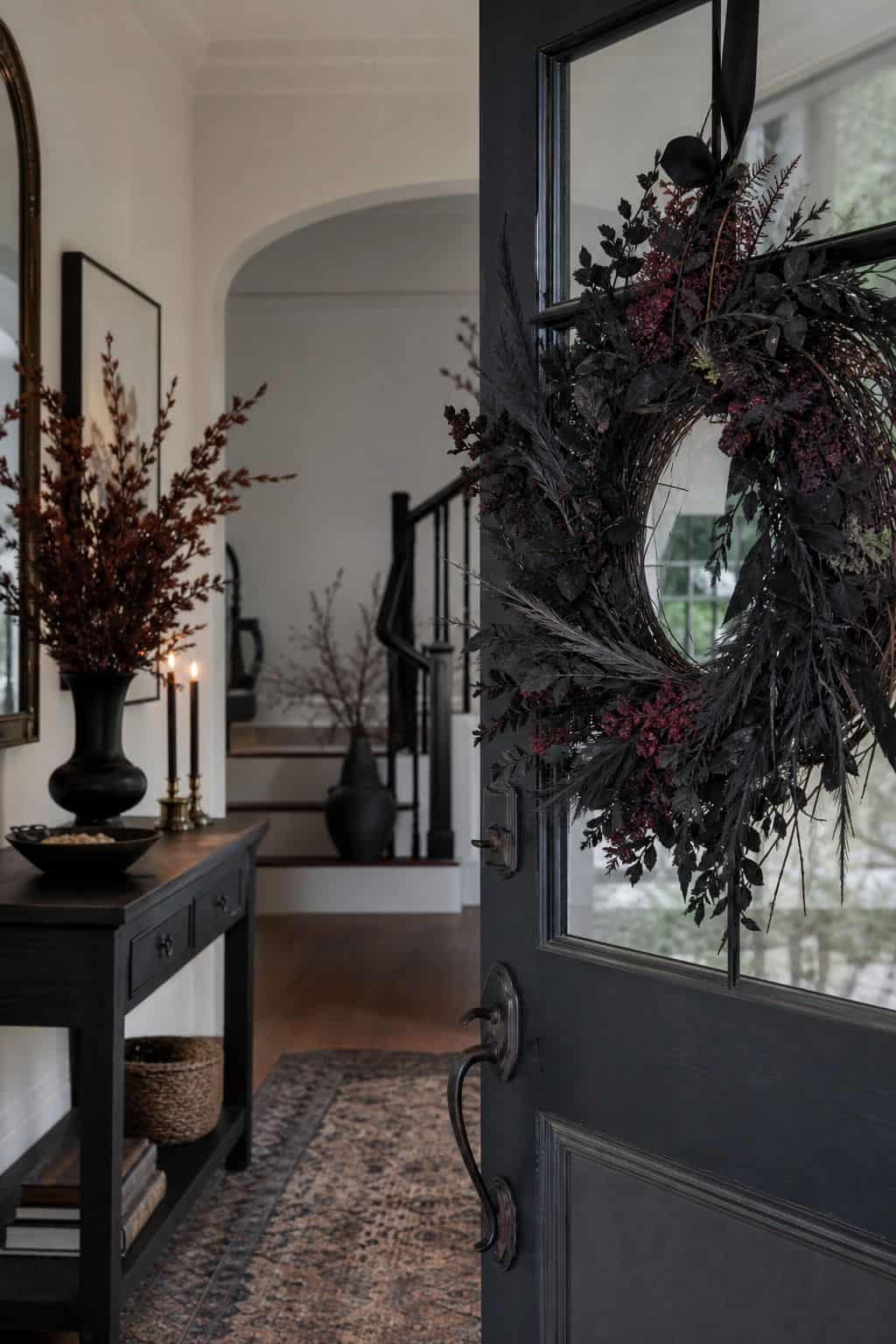 Dark Wreath Inside the Door shown as a realistic Pretty Wild World image for 17 Halloween Entryway Decor Ideas for a Stylish Spooky Welcome.