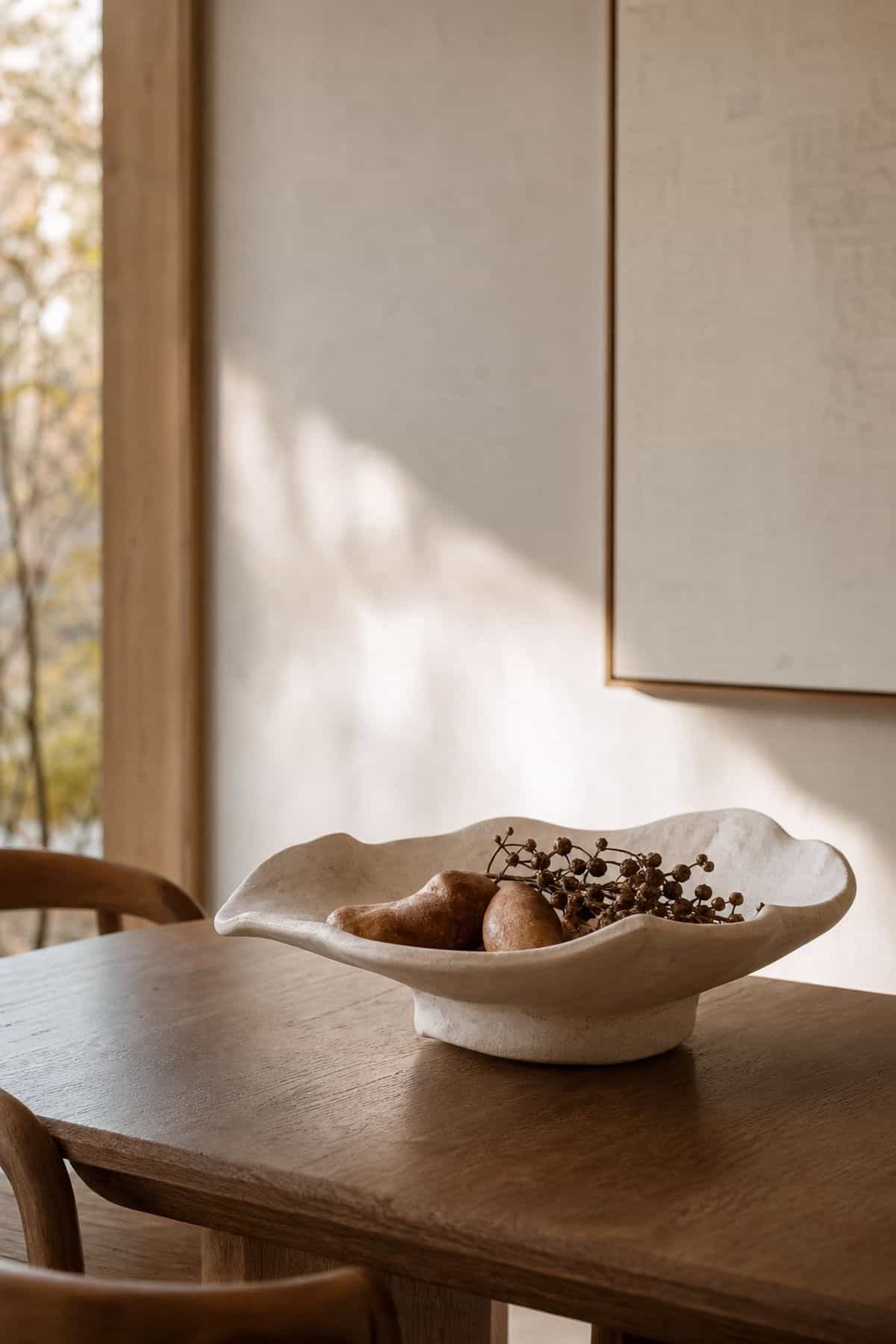 One Sculptural Bowl shown as a realistic Pretty Wild World image for 17 Modern Fall Decor Ideas for a Warm Minimal Home.