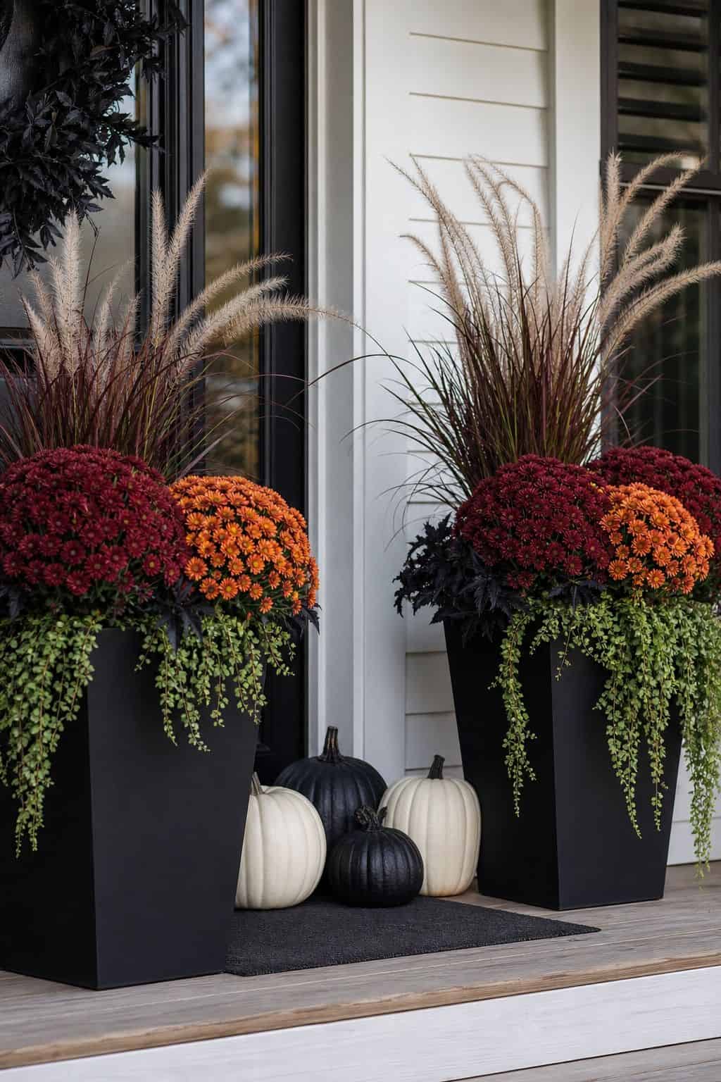 Black Planters With Mums shown as a realistic Pretty Wild World image for 18 Front Porch Halloween Decor Ideas for a Spooky Welcome.