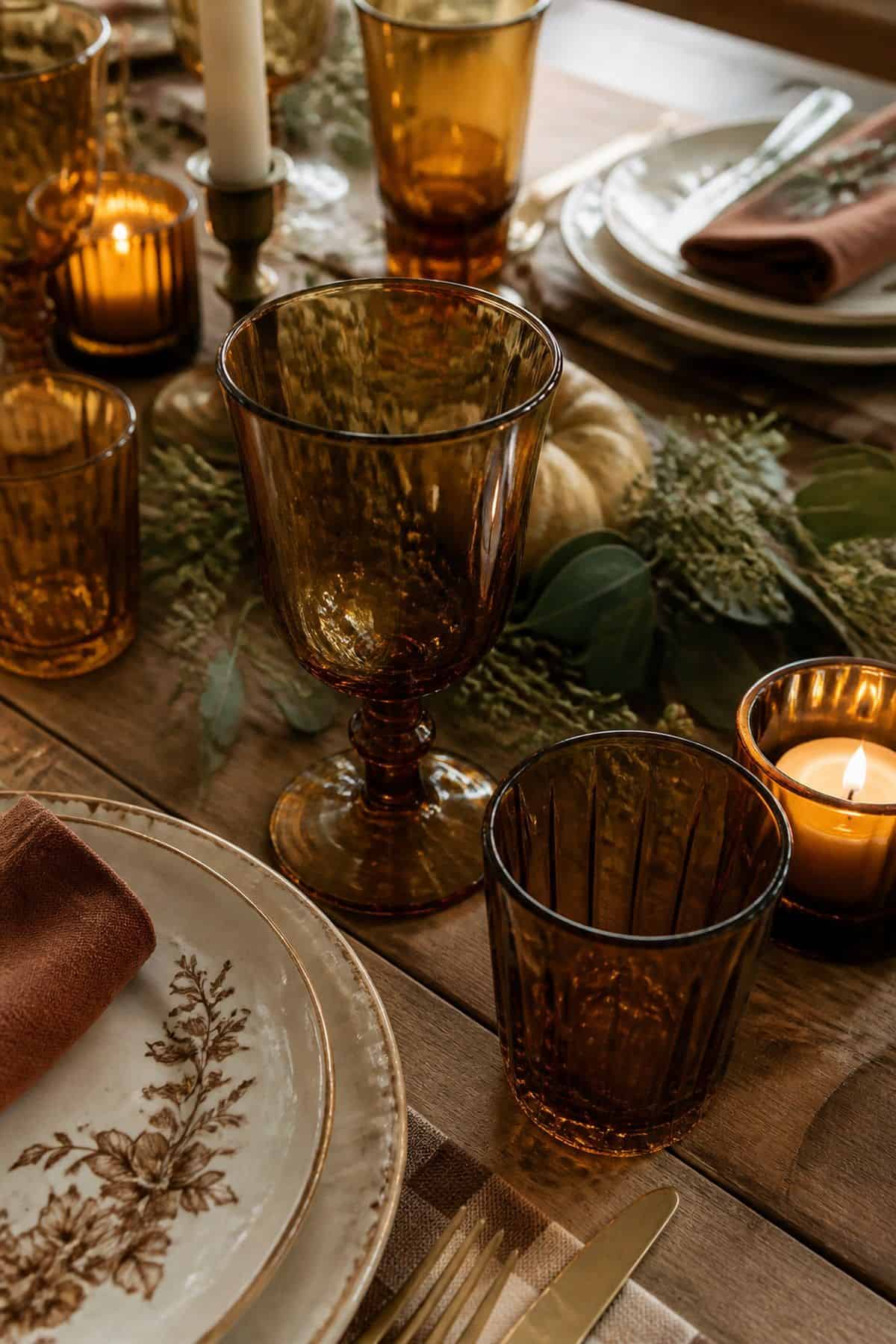 Amber glassware arranged on a warm Friendsgiving table