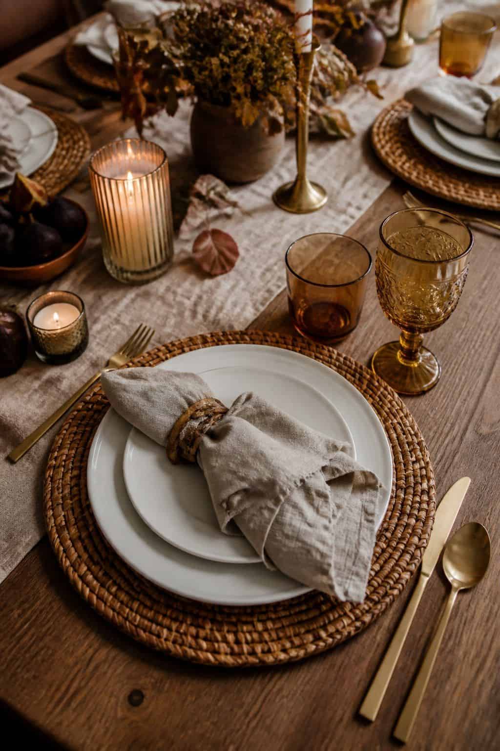 Simple Friendsgiving place settings layered over woven charger plates.