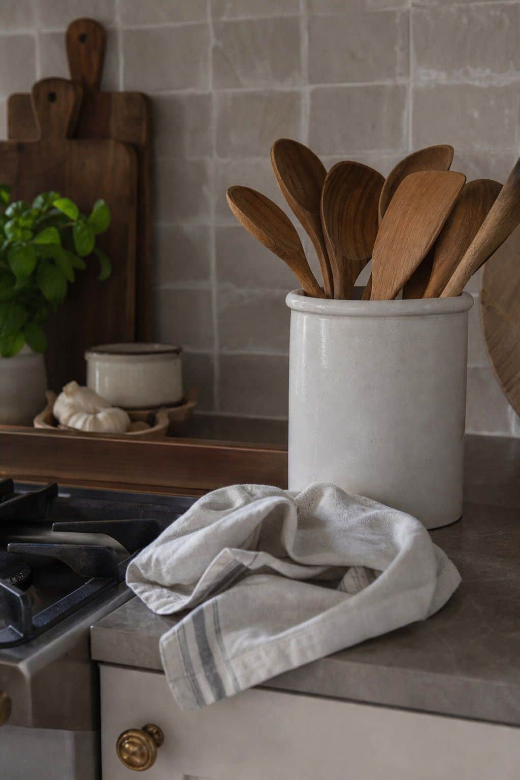 Summer kitchen decor with white utensil crock