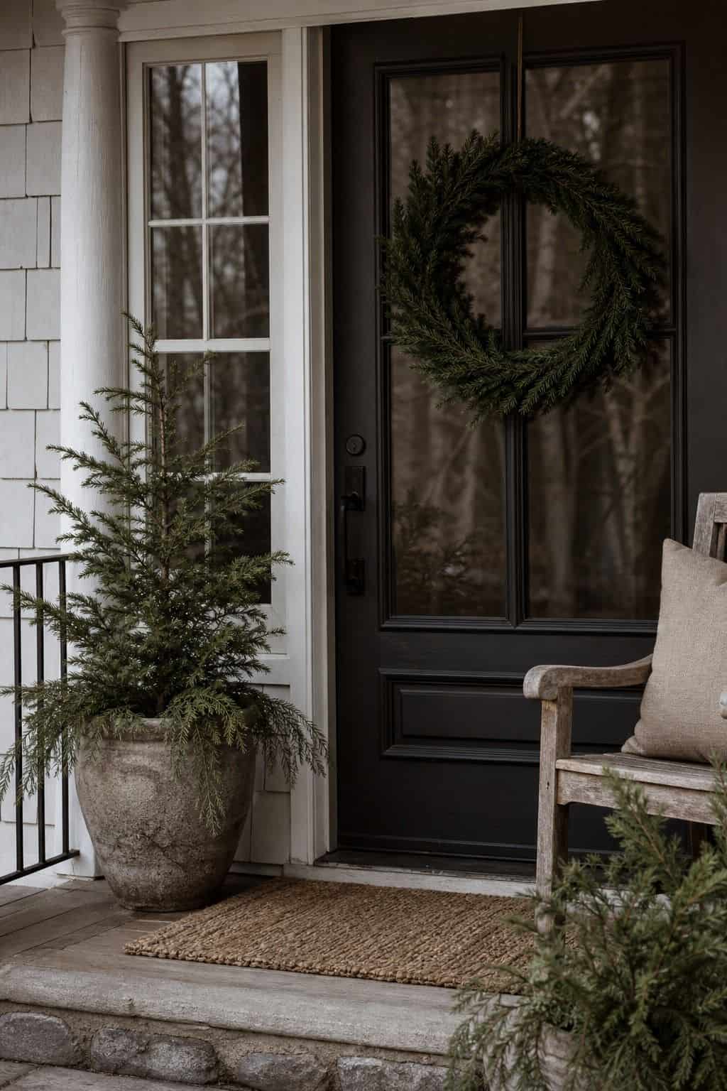 17. Porch Greenery Kept Simple winter home decor vignette with warm natural textures and soft daylight.