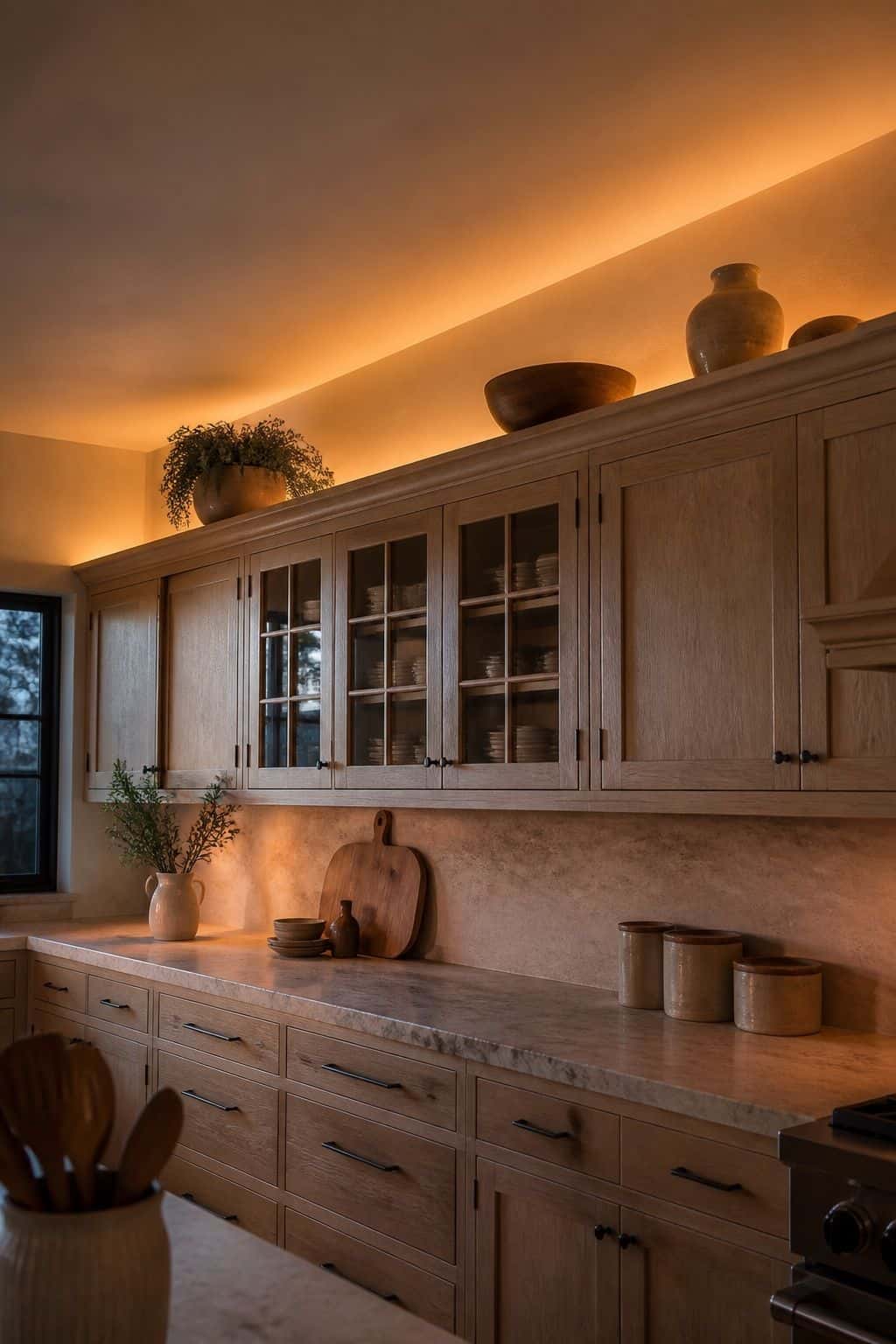 Soft lighting glowing above kitchen cabinets