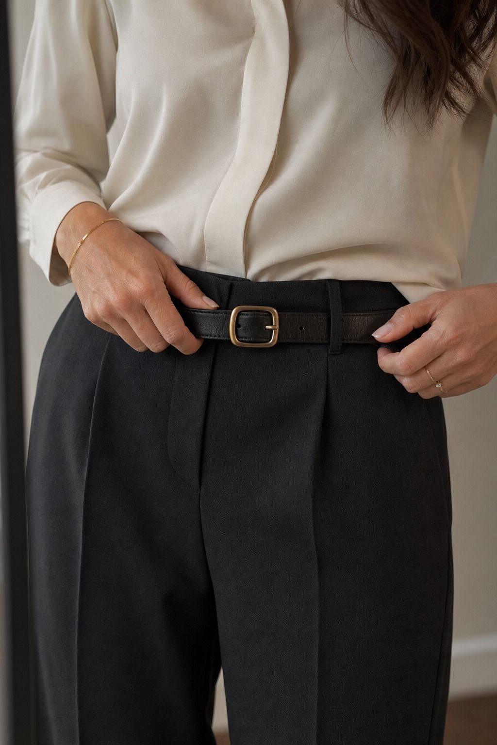 Women's corporate capsule wardrobe idea featuring minimal leather belt for polished work outfits.