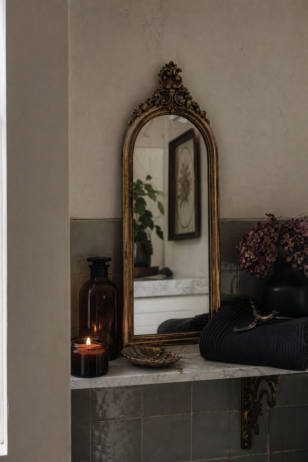 Small ornate gold mirror adding vintage style to a whimsigoth bathroom