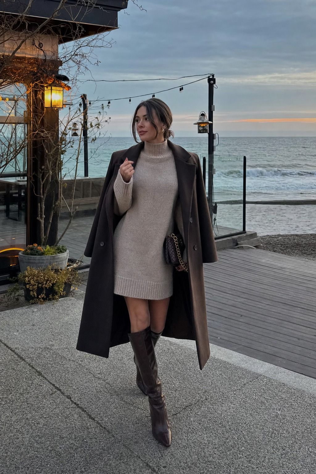 A Sweater Dress With Tall Boots for Dinner shown as a realistic Pretty Wild World image for 15 Cold Beach Day Outfit Ideas.