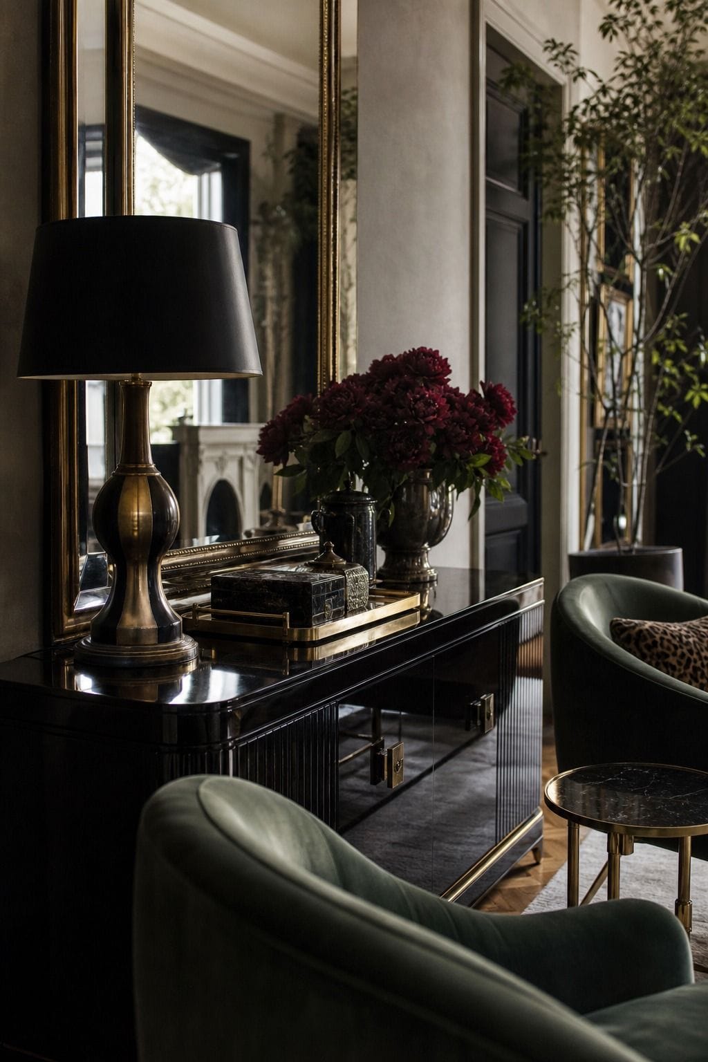 Hollywood Regency living room idea showing a lacquered console in a glamorous but livable space with velvet upholstery, brass details, glass or mirrored surfaces, crisp contrast, and layered decor. The image is meant to help readers picture how this specific design move can make a living room feel dramatic, polished, and editorial without becoming gaudy or overly themed, while still feeling comfortable enough for everyday hosting and lounging.