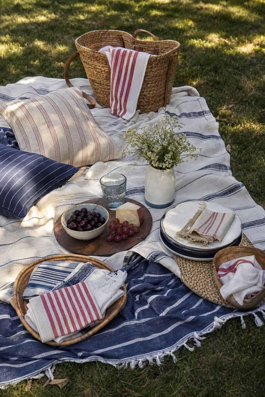 Layer picnic blankets shown as a realistic Pretty Wild World image for 16 Labor Day Home Decor Ideas for an Easy End-of-Summer Weekend.