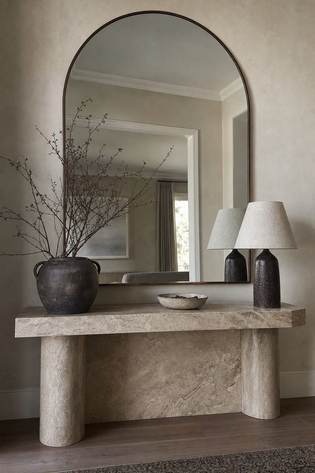 Use a Large, Eye-Catching Mirror as the Centerpiece shown as a realistic Pretty Wild World image for 15 Mirror Wall Decor Ideas That Make Your Home Feel Brighter and More Curated.