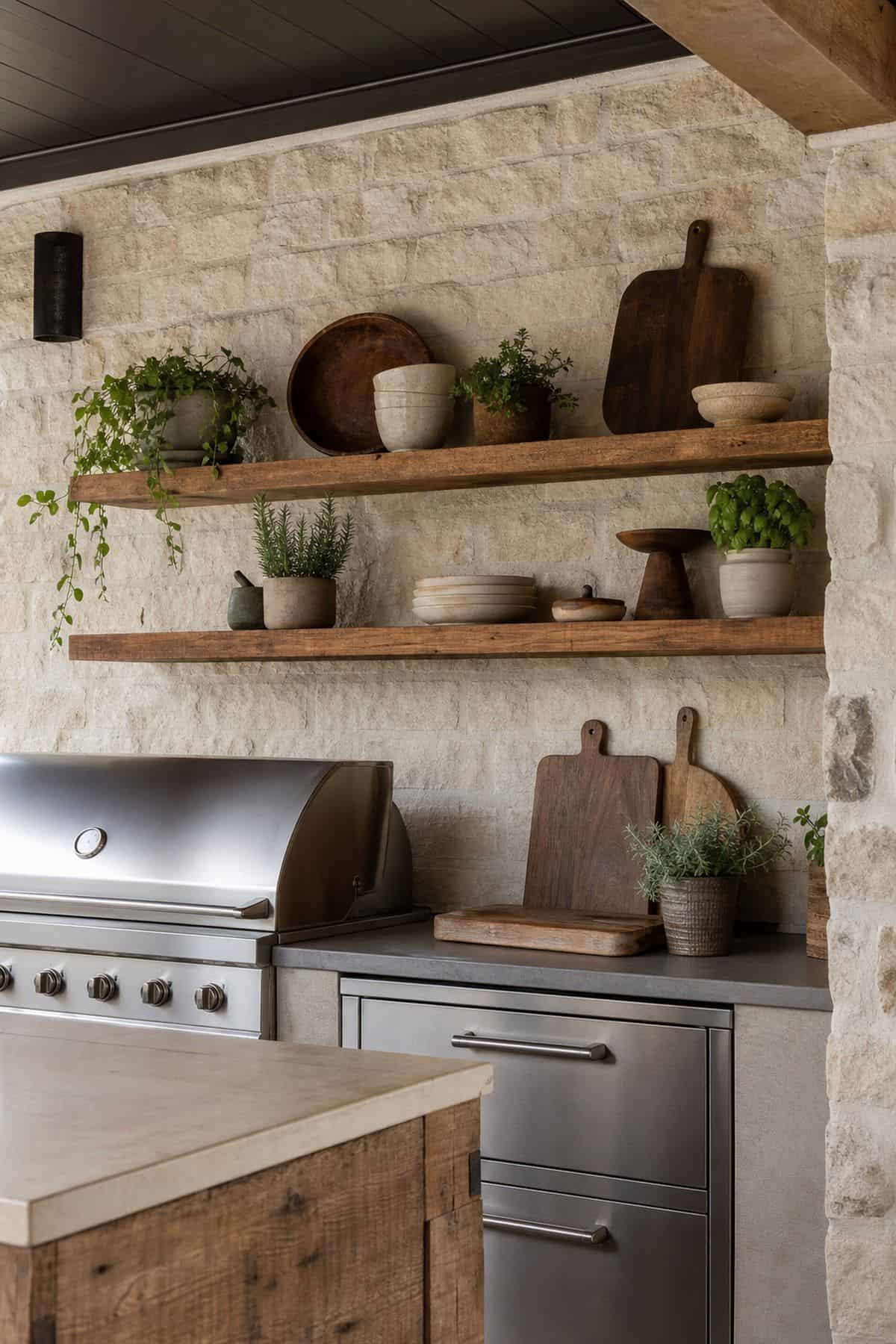 Mount shelves on walls for convenient storage and display shown as a realistic Pretty Wild World image for 15 Outdoor Kitchen Patio Decor Ideas for a Warm, Beautifully Styled Kitchen.