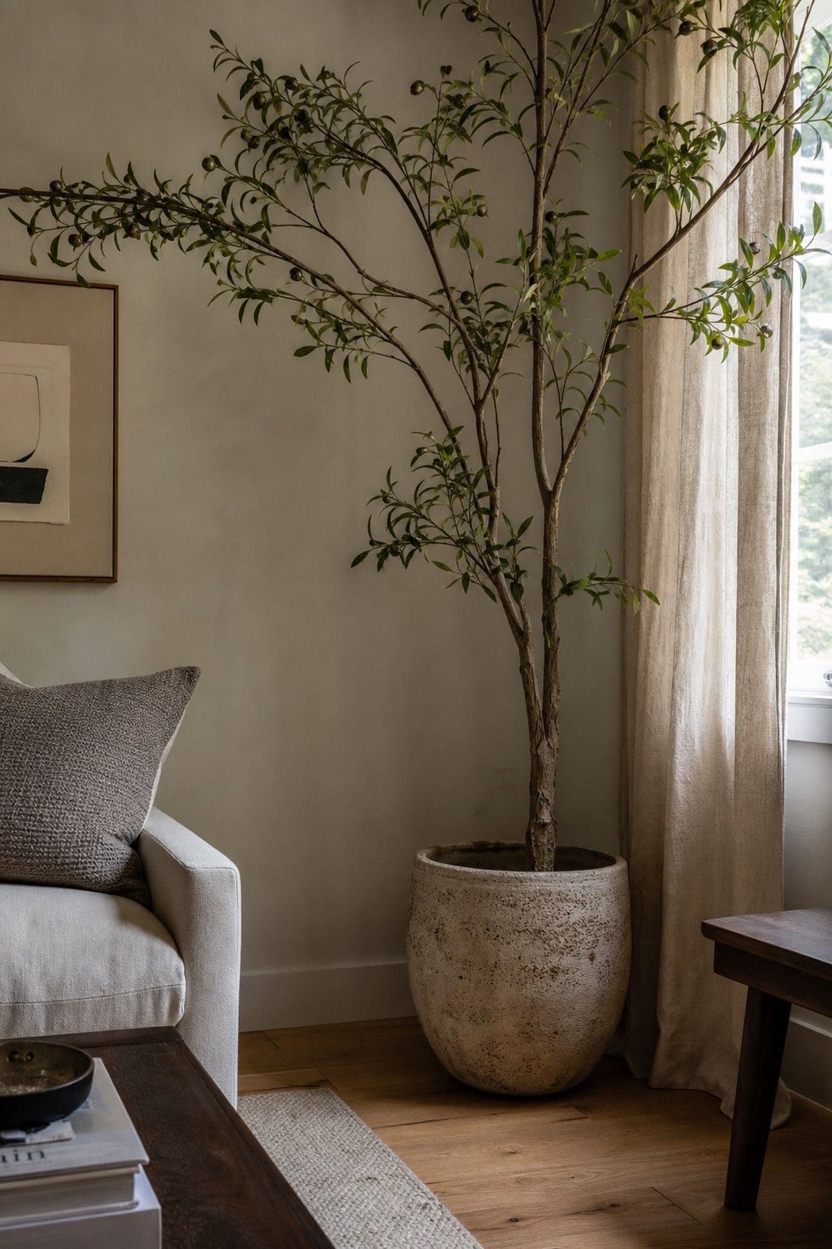 Set a Large Potted Plant or Small Tree in the Corner shown as a realistic Pretty Wild World image for 15 Room Corner Decor Ideas That Make Awkward Spaces Feel Intentional.