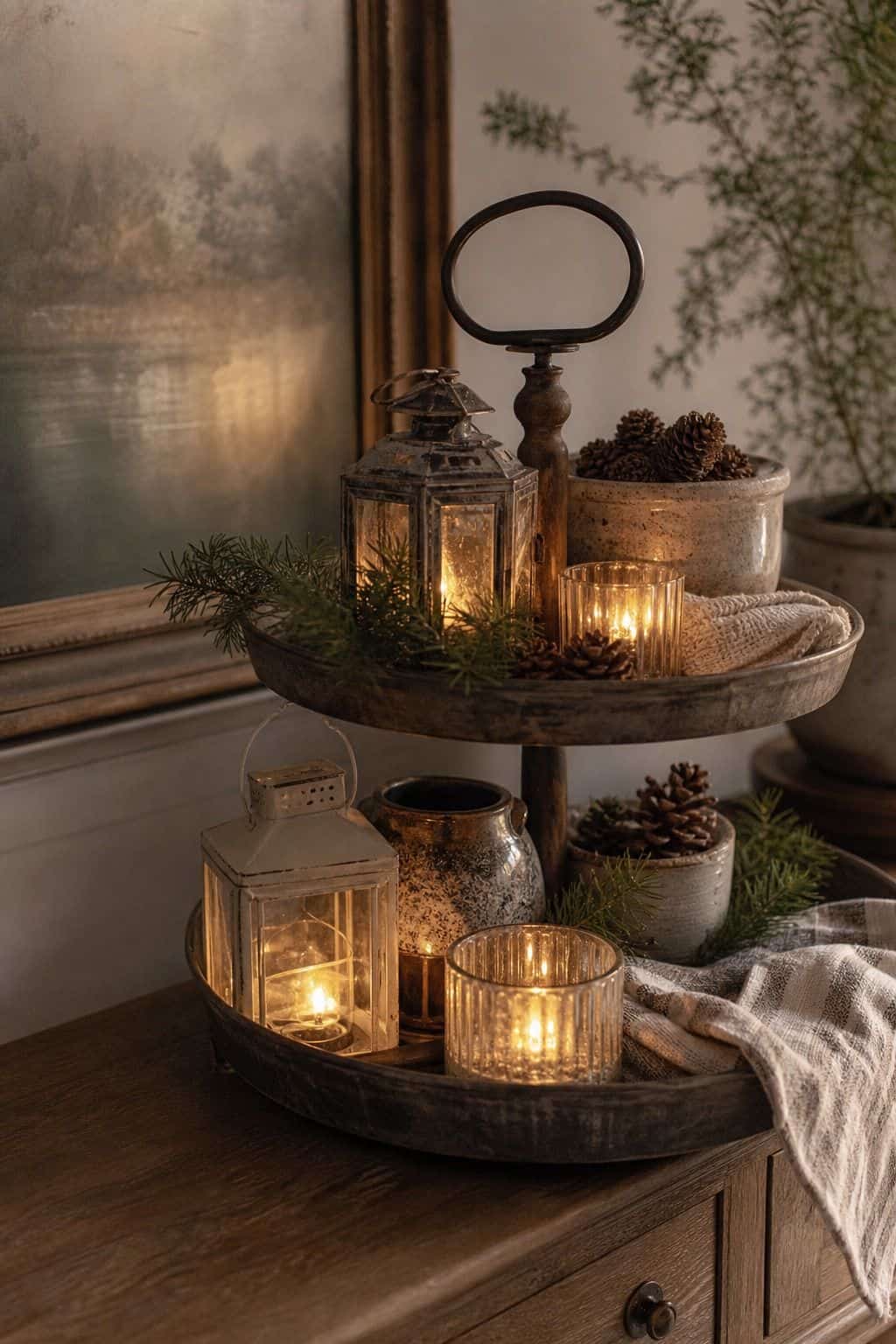 Arrange mini lanterns or candle holders for ambiance shown as a realistic Pretty Wild World image for 15 Winter Tiered Tray Ideas for a Collected, Seasonal Home Aesthetic.
